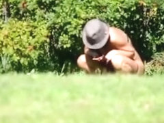 Peeing in the bushes in the meadow