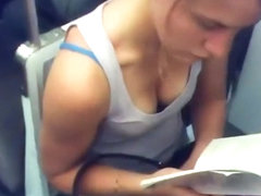 Busty teen girl reading in the train