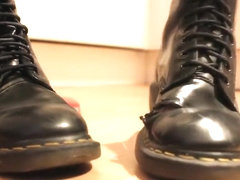 Girl wiggles her toes in soft, well worn Doc Martens and crushes a toy car