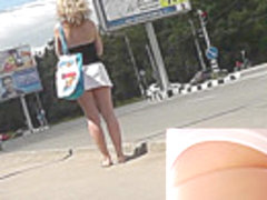 Plump blonde in white skirt and panties in upskirt clip