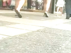 She is walking that street like a goddess in a black skirt