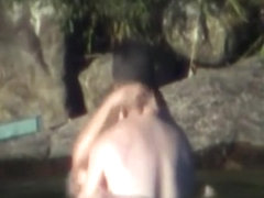 Voyeur tapes a couple having sex in a lake