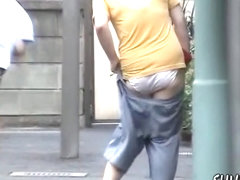 Street sharking with woman in jeans shorts 