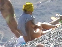 Hot red hair babe takes a nude sunbath at the beach