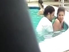 Pair copulates in public pool with people around 'em