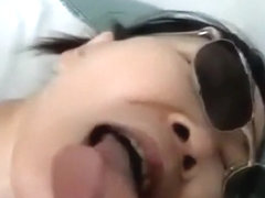Asian girl with sunglasses sucks cock, while getting fingered.