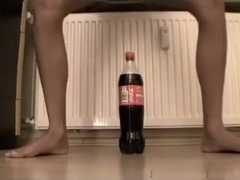 Small  immature tries to ride a coke bottle