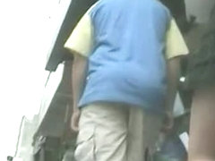 Enticing ass in a short skirt on an upskirt spy cam video